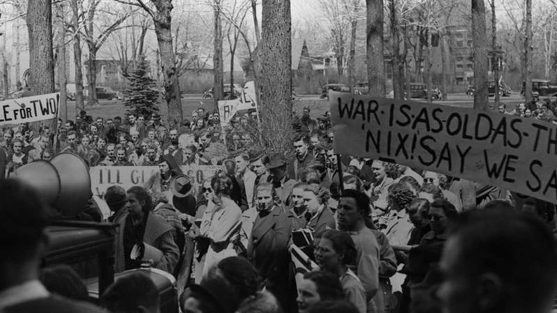 Students gather in large crowd across campus with protest signs