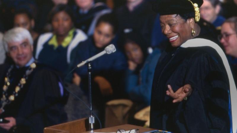 Maya Angelou standing behind a podium giving a speech