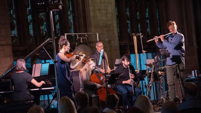 Performing group Eighth Blackbird in concert. Six musicians arrayed with their instruments. 