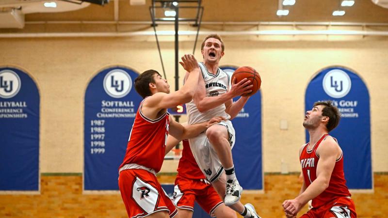 Brad Sendell drives to the basket amid three Ripon defenders.