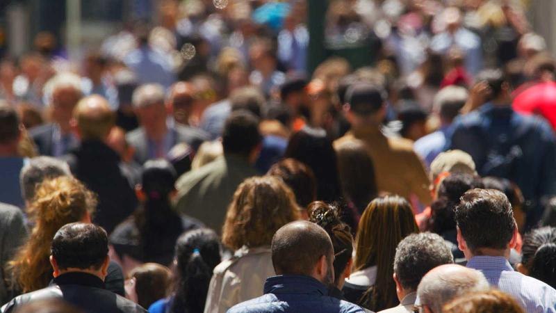 Crowded sidewalk full of people