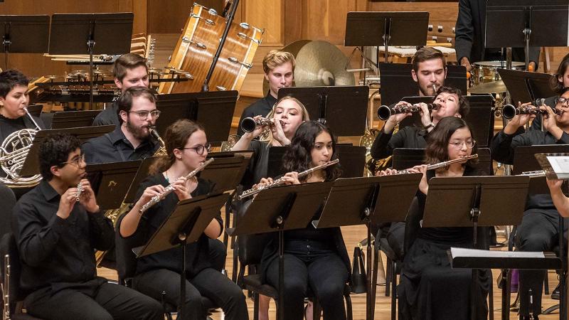 Students play instruments on stage