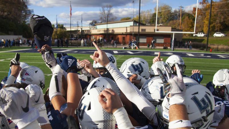 Football team gathering for pre-game huddle