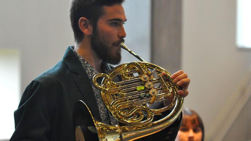 Student playing horn