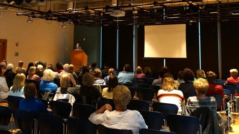 Community members listen to a lecture in Warch Campus Center