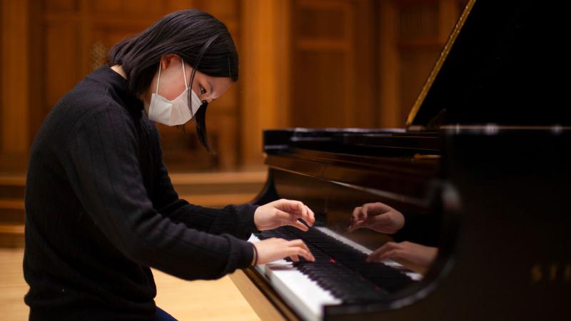Student plays piano in Memorial Chapel