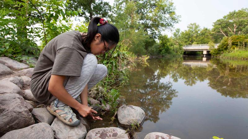 Student looking into a river