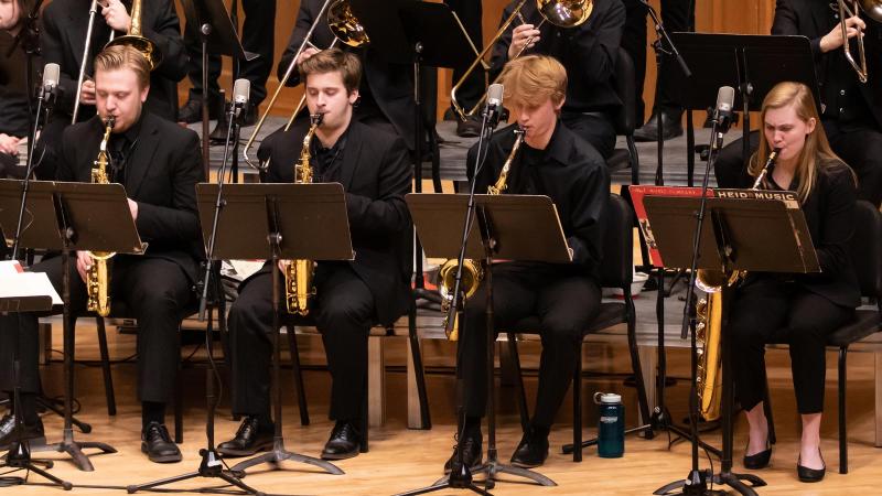 Group of saxophone players sitting down