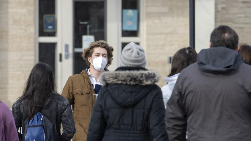Student tour guide shows families around campus.