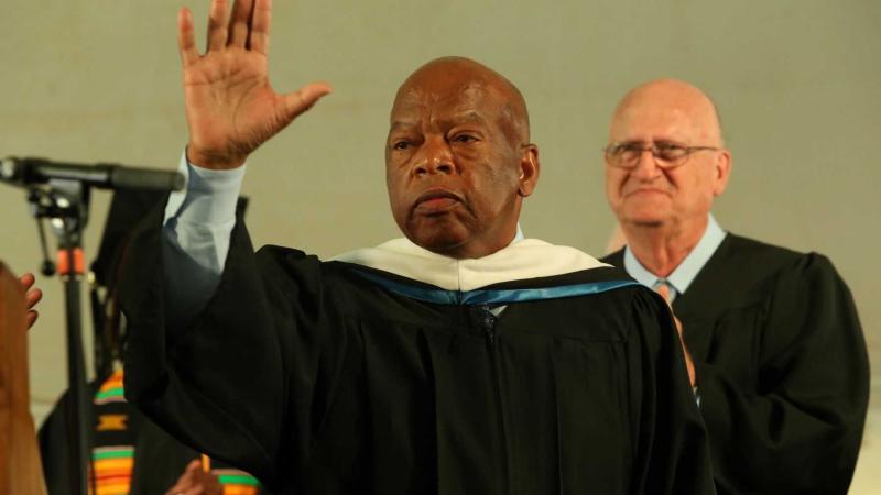 John Lewis waves from the stage during the 2015 Commencement ceremony.