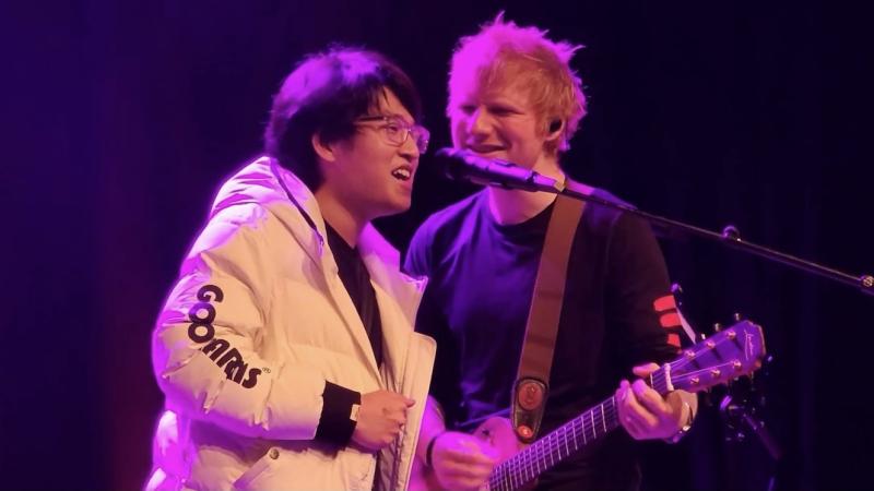 Michael Zhang sings at the microphone with Ed Sheeran