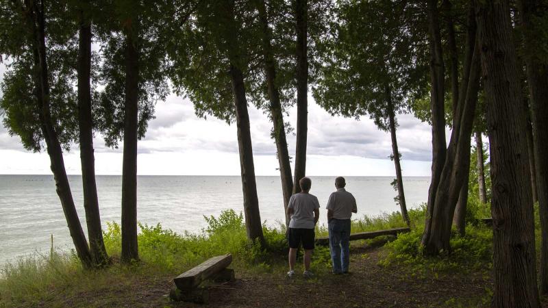Two people looking at Lake Michigan from shore