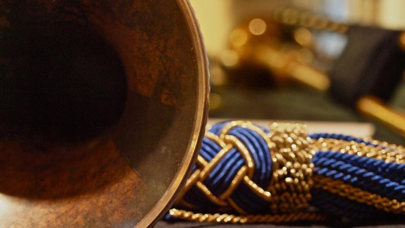 close up of trumpet with gold and blue strings 