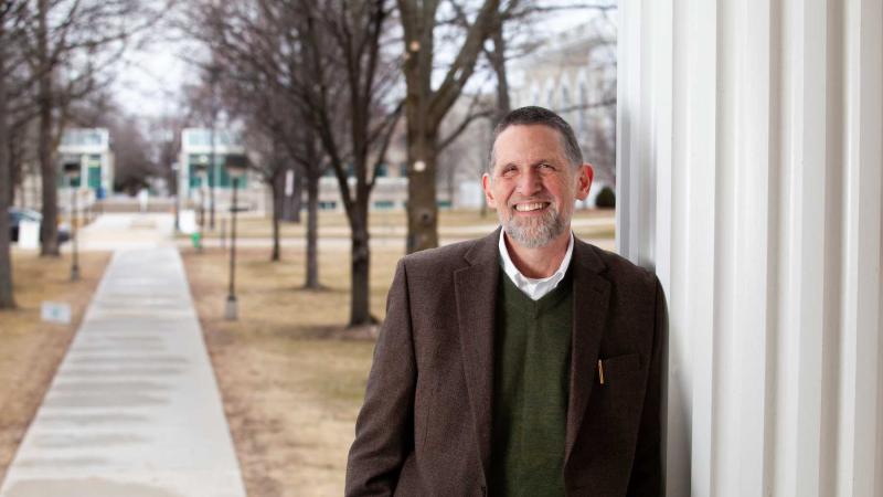 Peter Peregrine stands in front of Main Hall.