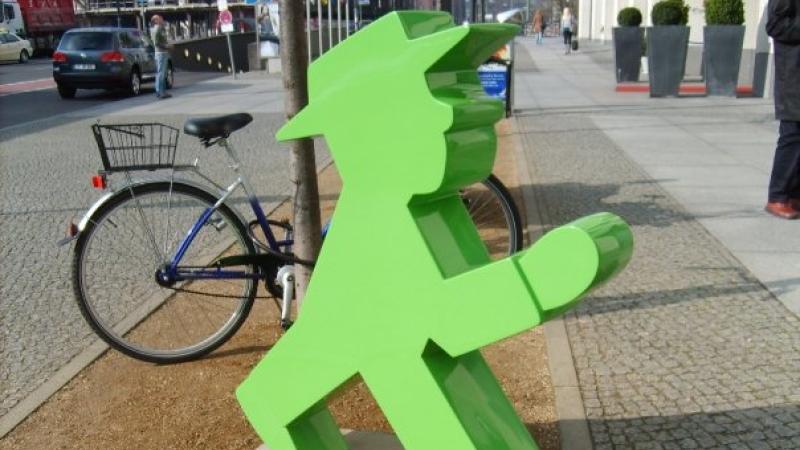 A statue of the green walking Ampelmann, the pedestrian symbols used in Germany.