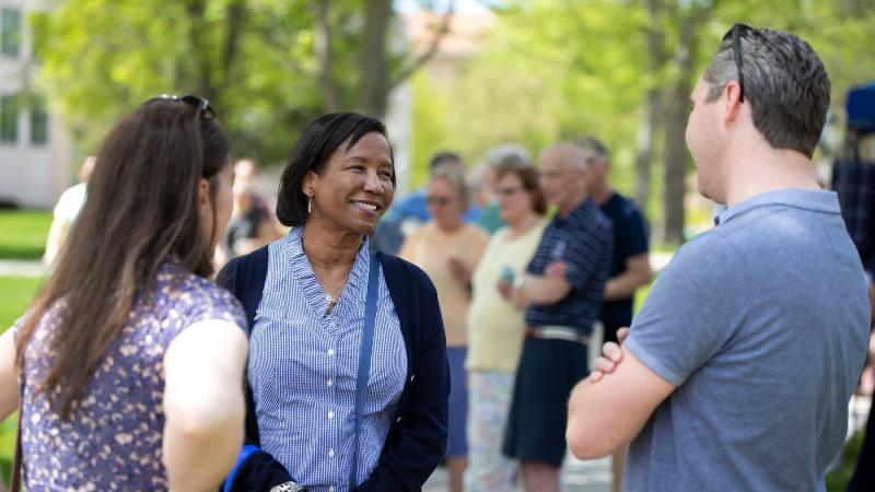 President Laurie A. Carter talks with two people at the Brighter Together Picnic.