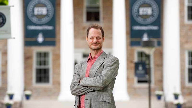 Austin Segrest folds his arms as he poses in front of Main Hall.