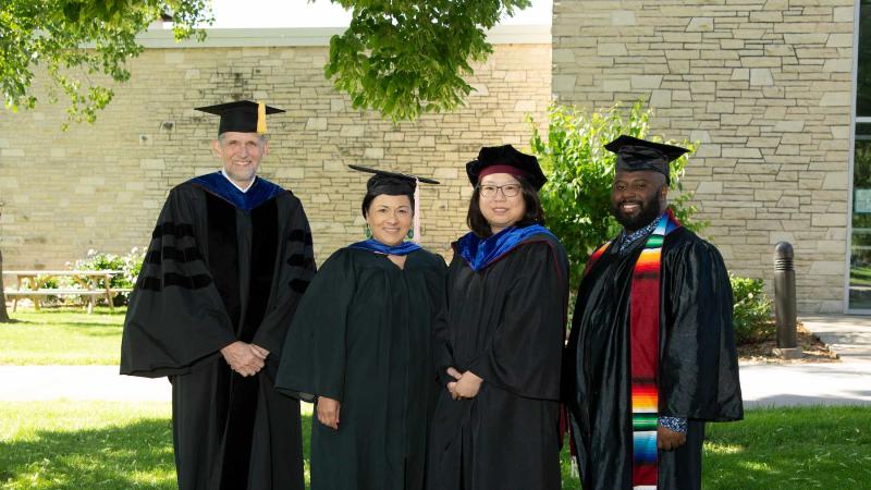 Faculty award winners, from left, Peter Peregrine, Brigetta Miller, Nancy Lin, and Jesus Smith pose for a photo in their regalia.