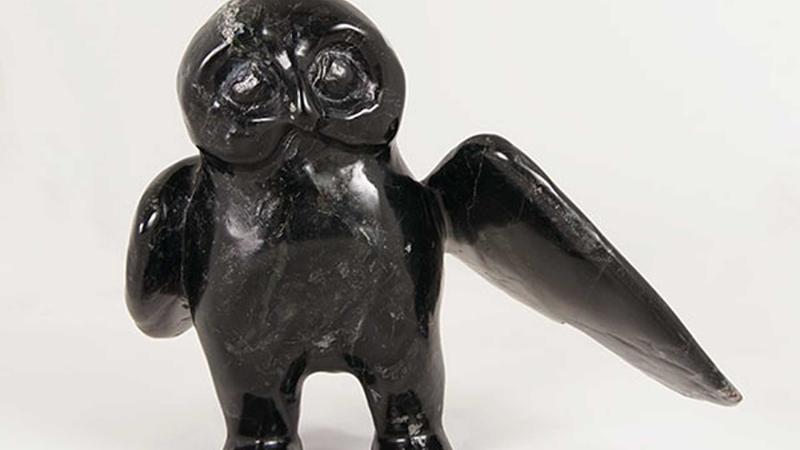 Stylized owl carved out of black stone