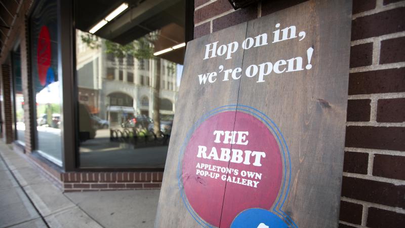 A sign welcomes visitors to the pop-up art gallery in City Center Plaza.