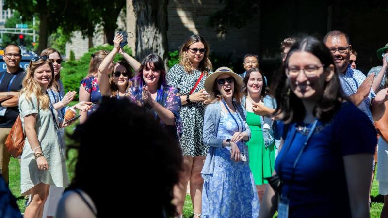 Reunion attendees laugh and wave during the Parade of Classes.