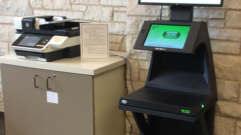 KIC overhead scanner next to a standard bed scanner.