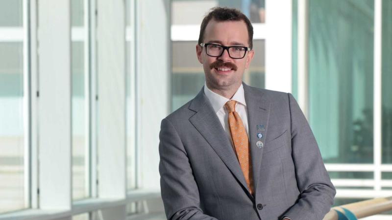 Matt Murphy, dressed in a suit and tie, poses for a photo during Reunion weekend.