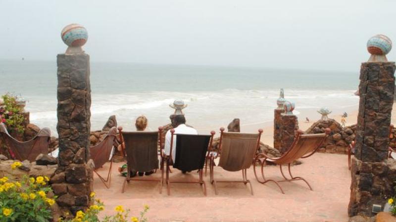 Students sitting in chairs facing away from camera viewing the beach.