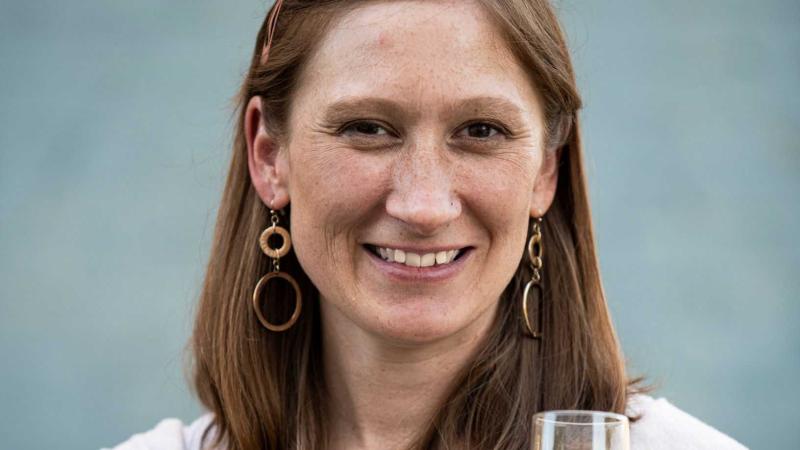 Josie Boyle holds a glass of wine.