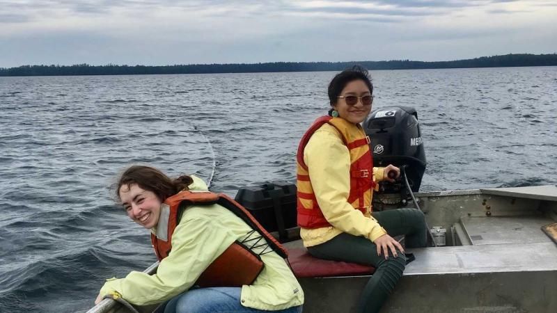 Eleanor Meng and Reese Lavajo cruise Trout Lake in a small boat as do research.