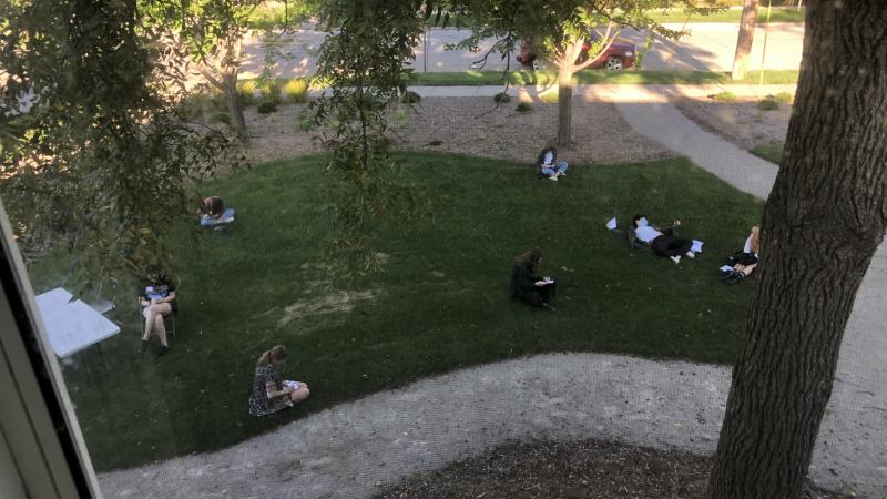 Photo taken through window of students lounging in the Goldgarden.