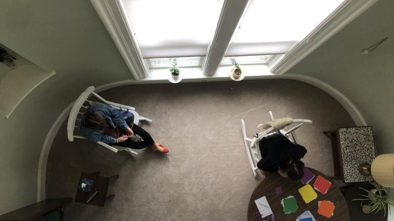 Two students viewed from above in meditation space.