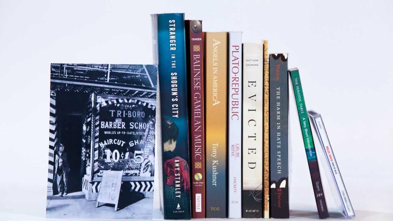 Photo of books and other First-Year Studies materials lined up on a shelf.