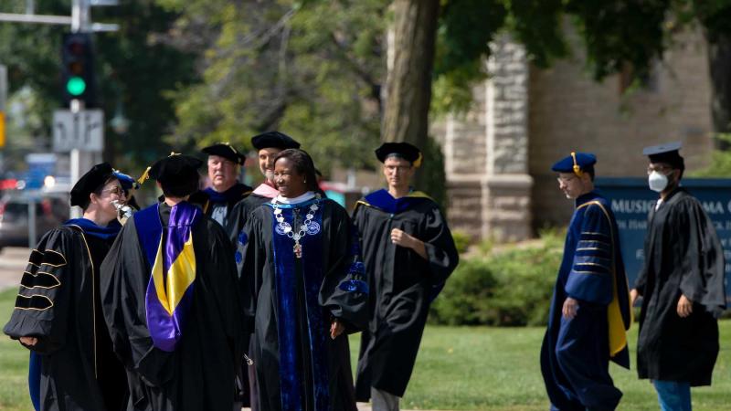 President Laurie Carter walks with faculty members at the front of the procession on the way into Memorial Chapel.