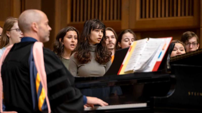 Stephen Sieck plays the piano as he leads the Welcome Week Choir in a performance during the convocation.