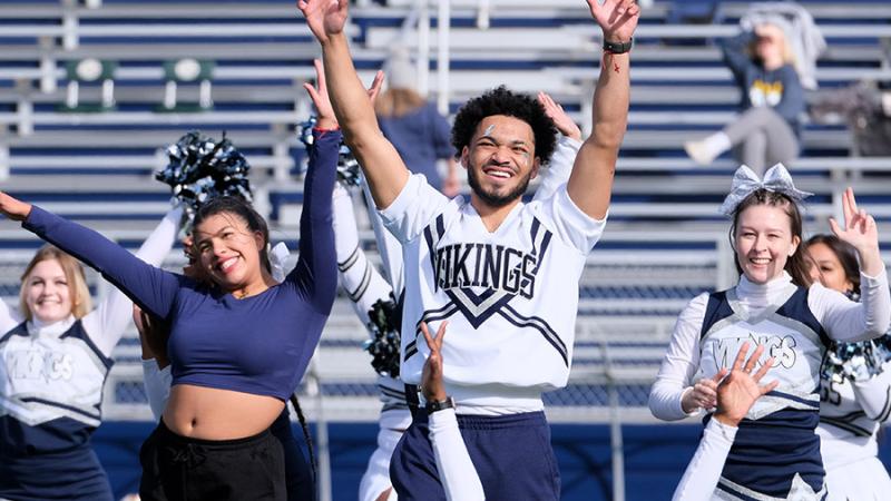 Cheer team routine during football game