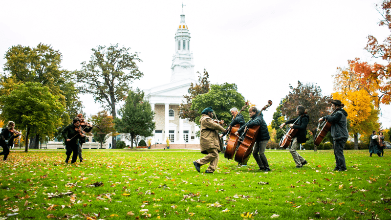 People play isntruments outside in front of Lawrence Chapel