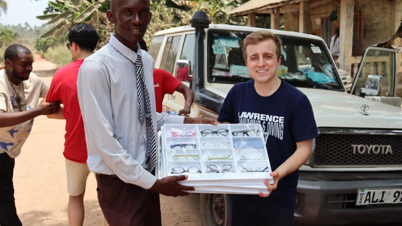 AJ Ulwelling with Mr. Francis Mason, who is the founder of Conforti School in Freetown, one of the KidsGive partner school.  AJ is sharing with him some glasses, a donation that was part of the EyeGive project that emerged from my social entrepreneurship class between 2021 and 2022.