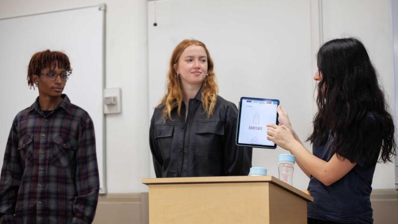 Senior Kate Oztunc shows a screen and talks as classmates look on during their Innovation & Entrepreneurship class. 