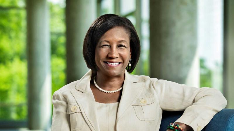 Portrait of President Laurie A. Carter, sitting in front of windows in Warch Center.