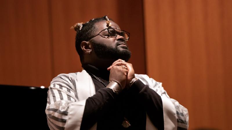 John Holiday clasps his hands as he sings during Thursday's tribute to Martin Luther King Jr.