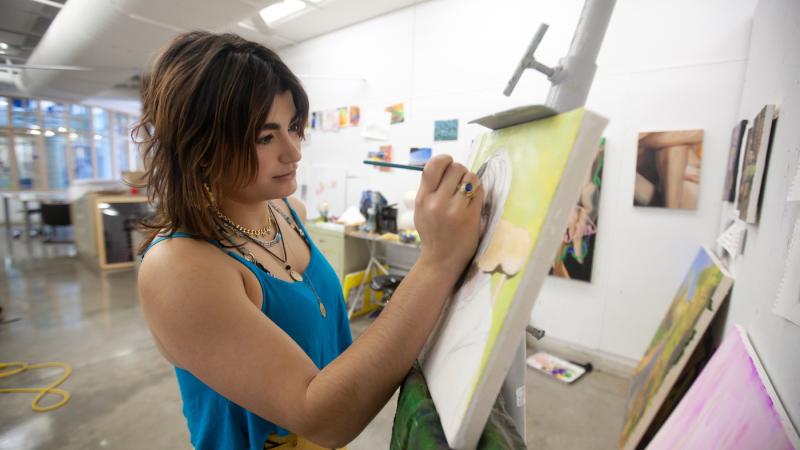 Marifé Entenza-Sierra, a studio art major at Lawrence, works on her oil painting in Wriston Art Center.