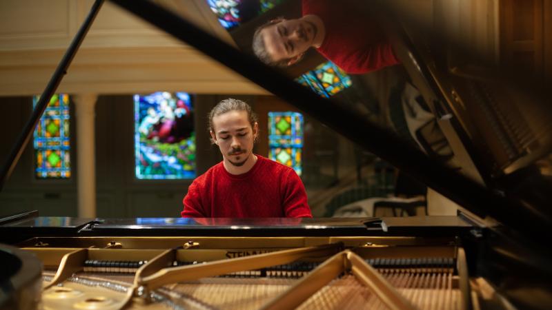 Bohdan Tataryn plays the piano on the Memorial Chapel stage.