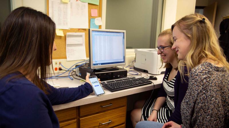 Psychology students reviewing a phone app for child emotional development