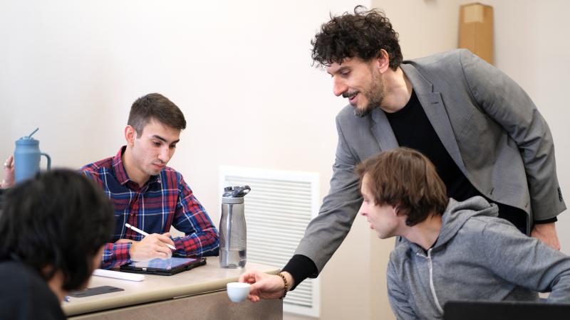 Greg Milano talks coffee and shows students a cup of espresso during a class session.