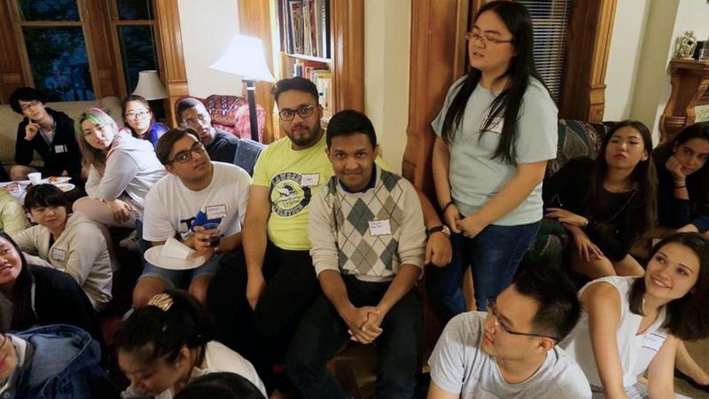 Students gathered in the living room of the International House