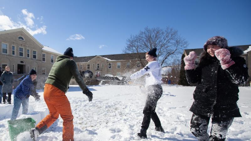Lawrence students play in the snow during a LUgge snow-sculpture event in the Quad.