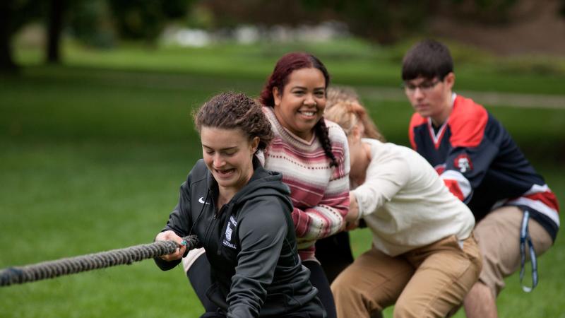 Students playing tug of war for wellness and team building