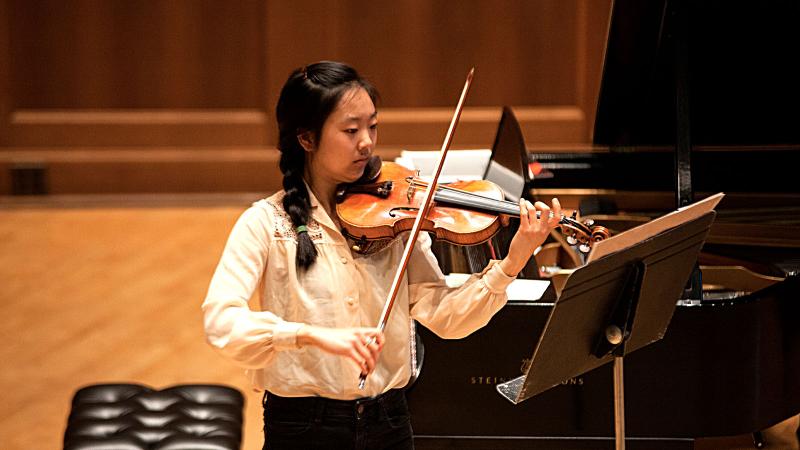 Violin student playing in Lawrence Memorial Chapel