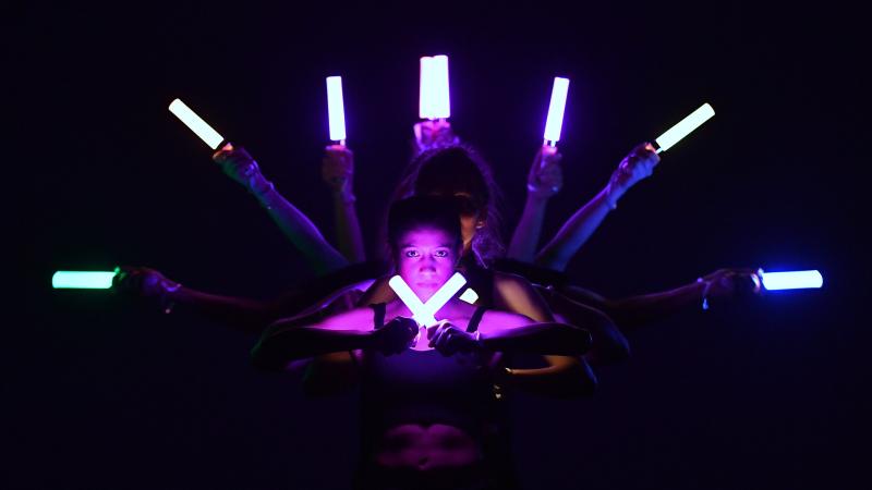 Performers hold lights during a dance performance at Cabaret.